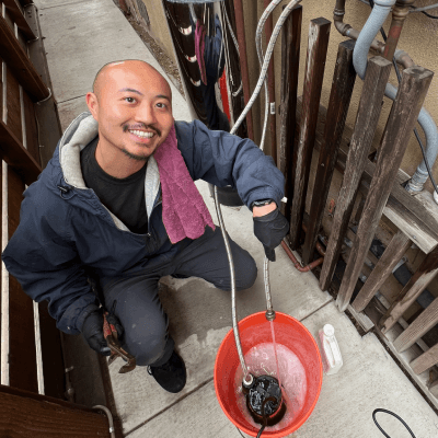 Plumber working on pipes